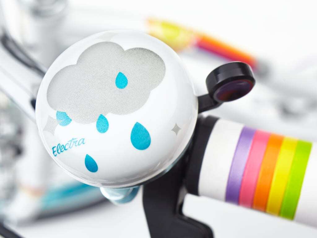 White electronic device with cloud design and colorful accents on a blurred background