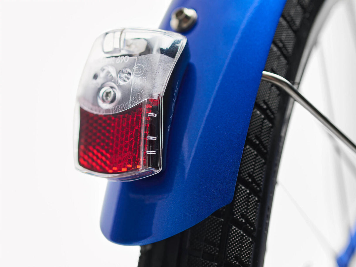 Close-up of a bicycle tail light attached to a blue bike frame.