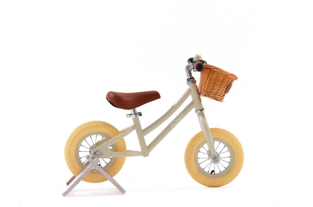 Children's balance bike with a basket on a white background