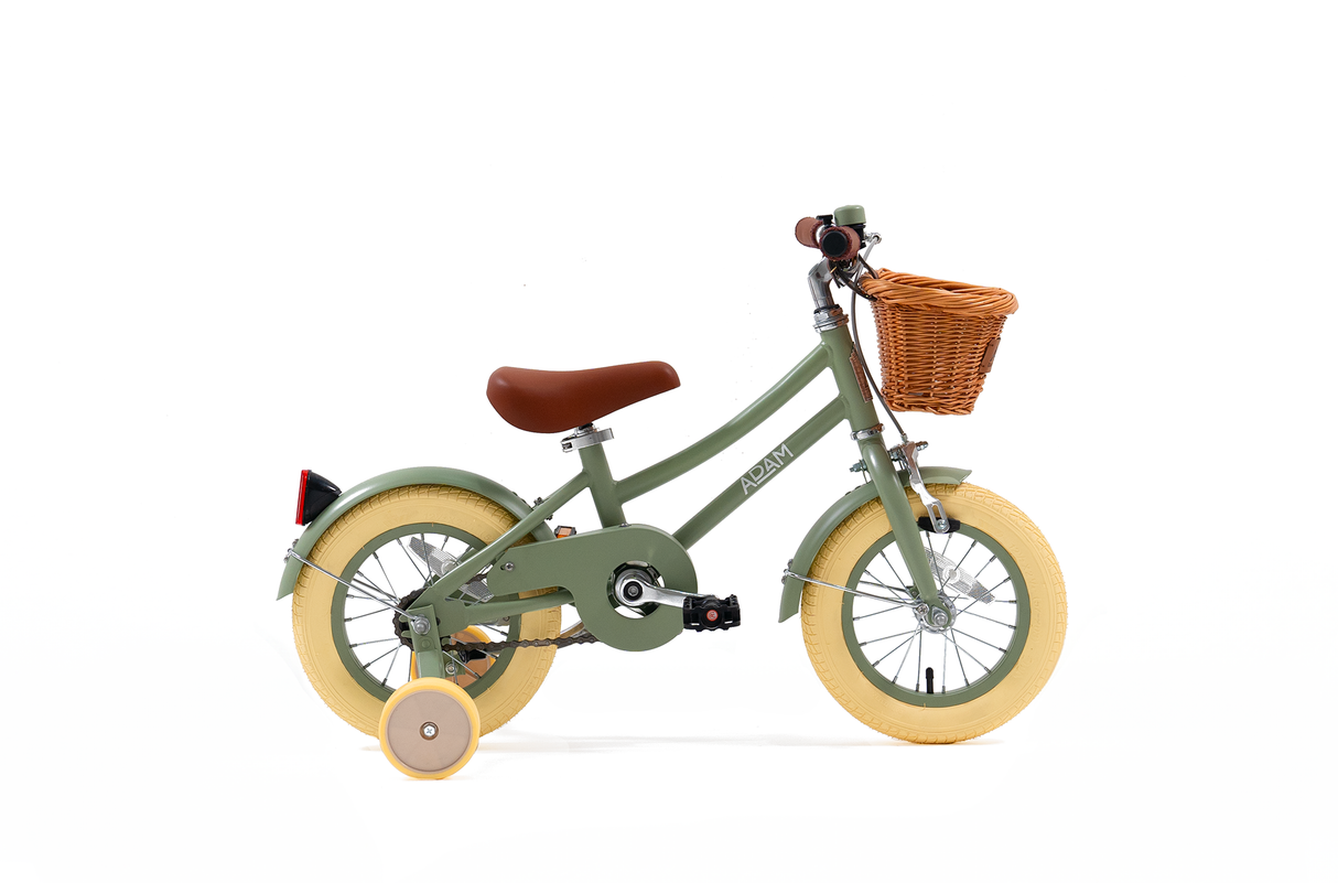 Green children's bicycle with a basket on a white background