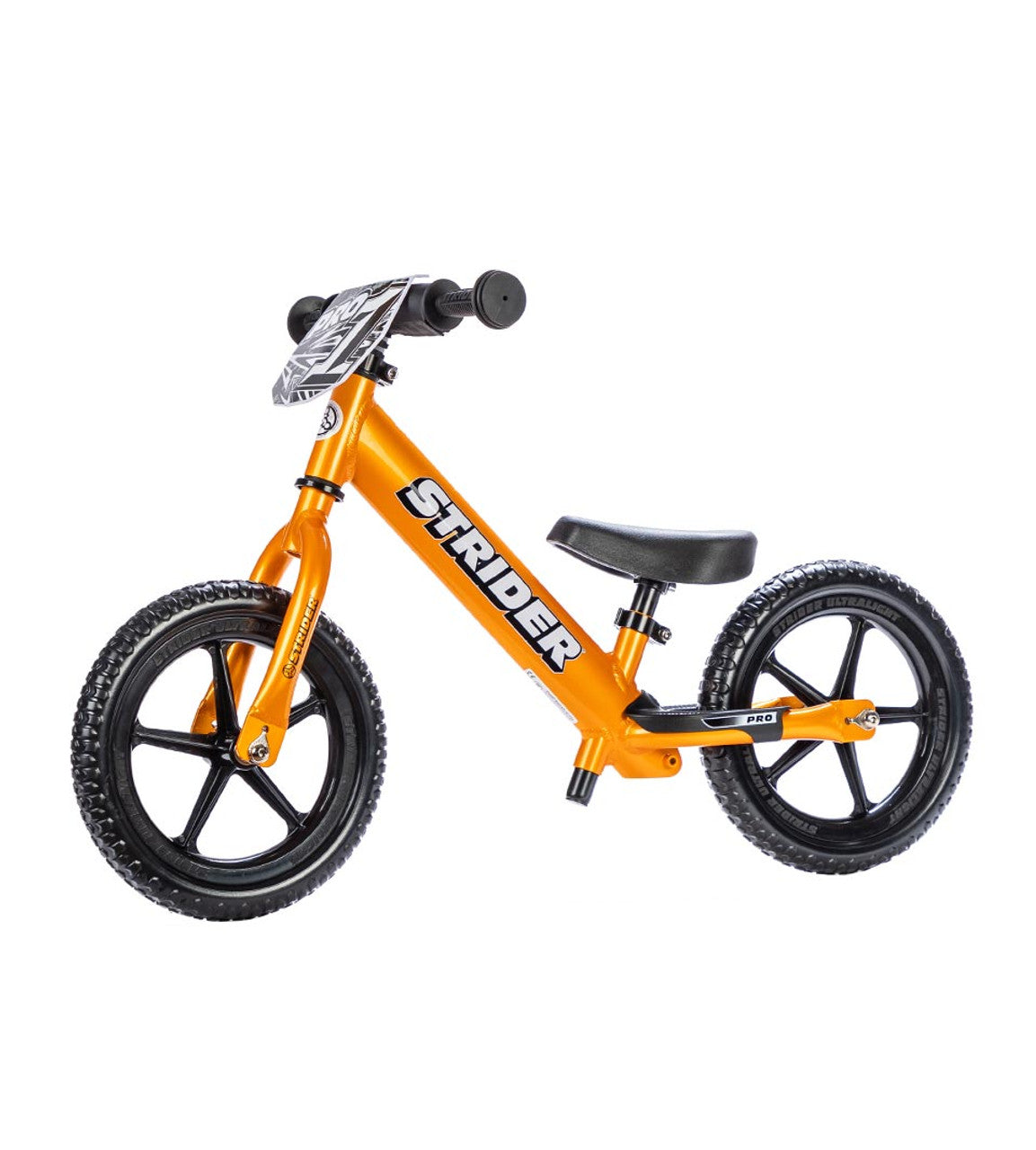 Orange Strider balance bike on a white background