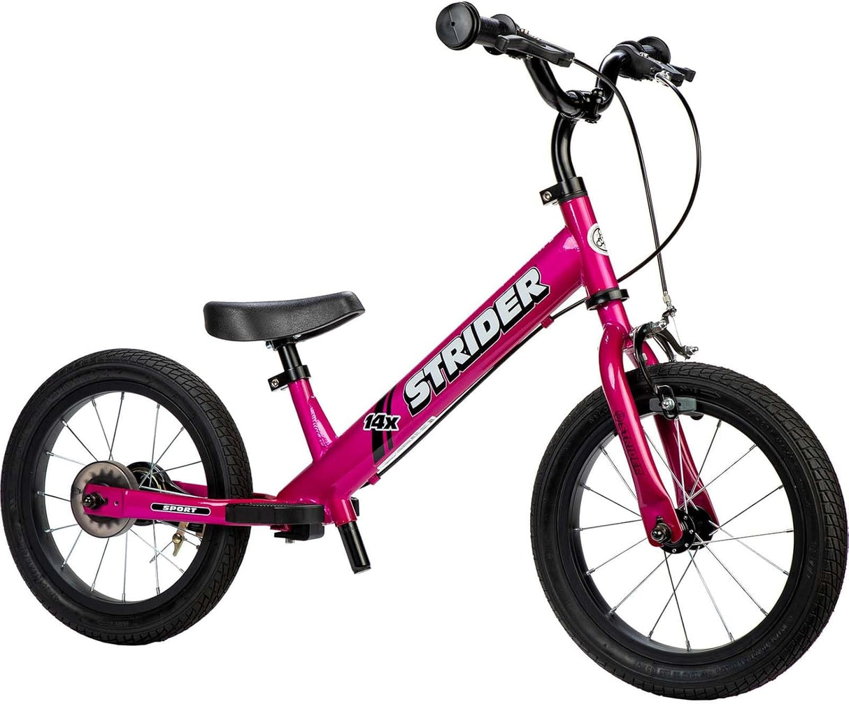 Pink Strider balance bike on a white background