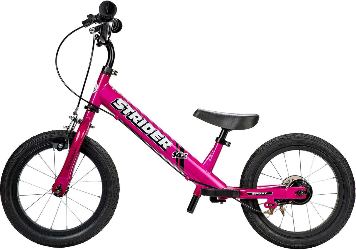 Pink Strider balance bike on a white background