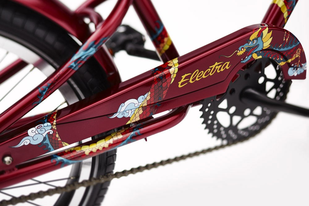 Close-up of a red bicycle frame with colorful designs and 'Electra' branding.