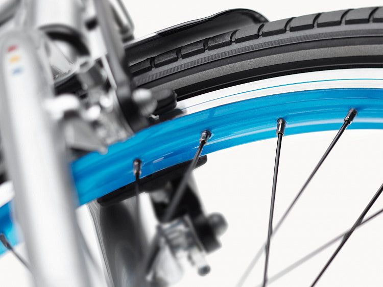 Close-up of a bicycle wheel with blue rim and black tire