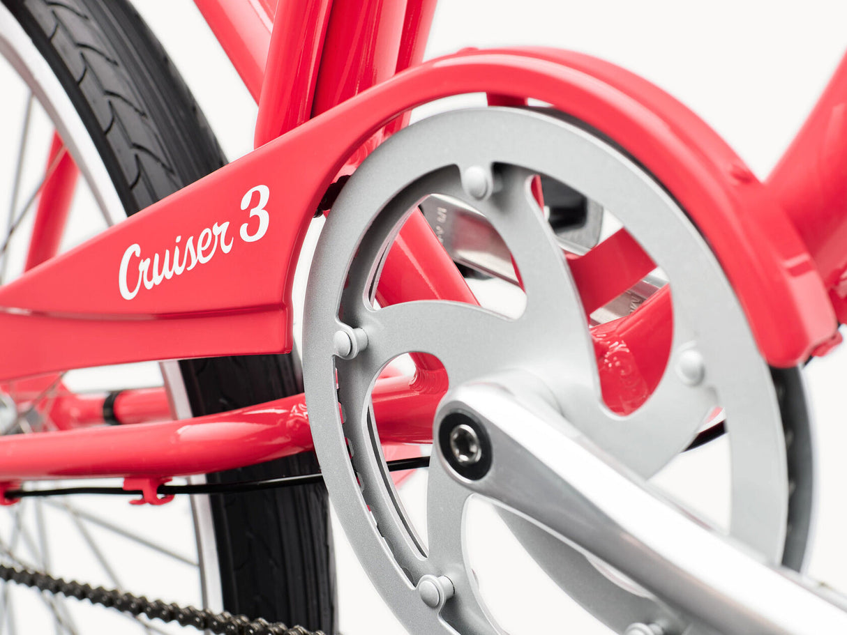 Close-up of a red bicycle with 'Cruiser 3' branding on a white background