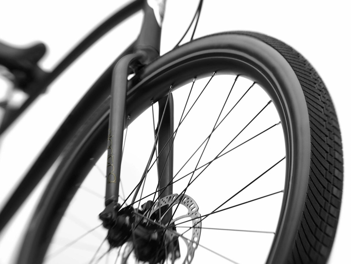 Close-up of a bicycle wheel with a blurred background