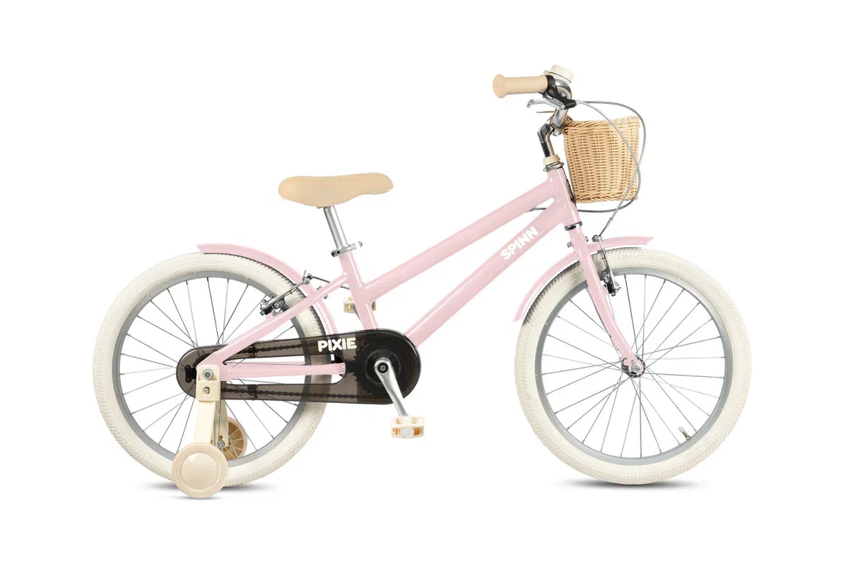 Pink children's bicycle with a basket on a white background