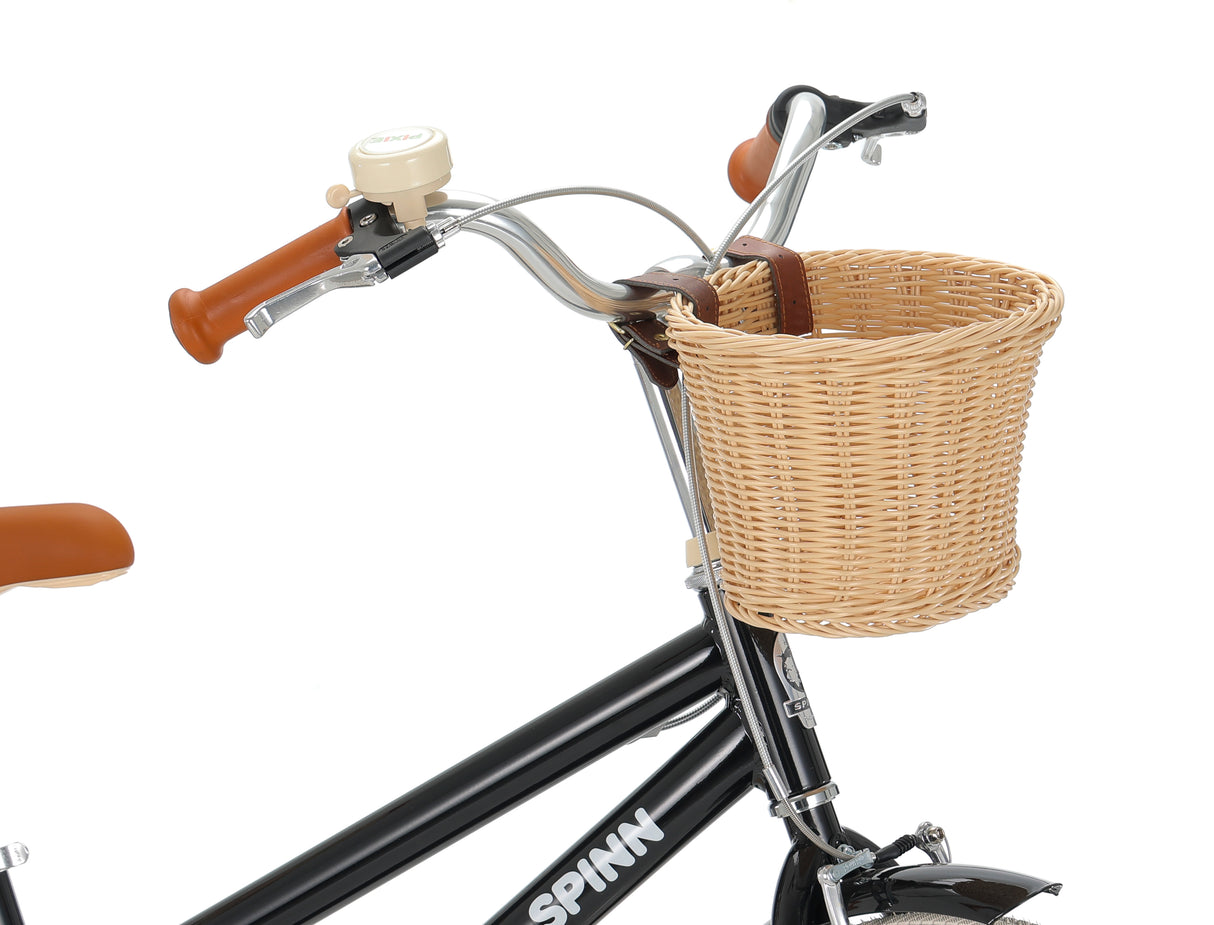 Bicycle with a wicker basket on a white background, featuring the brand 'SPINN'.