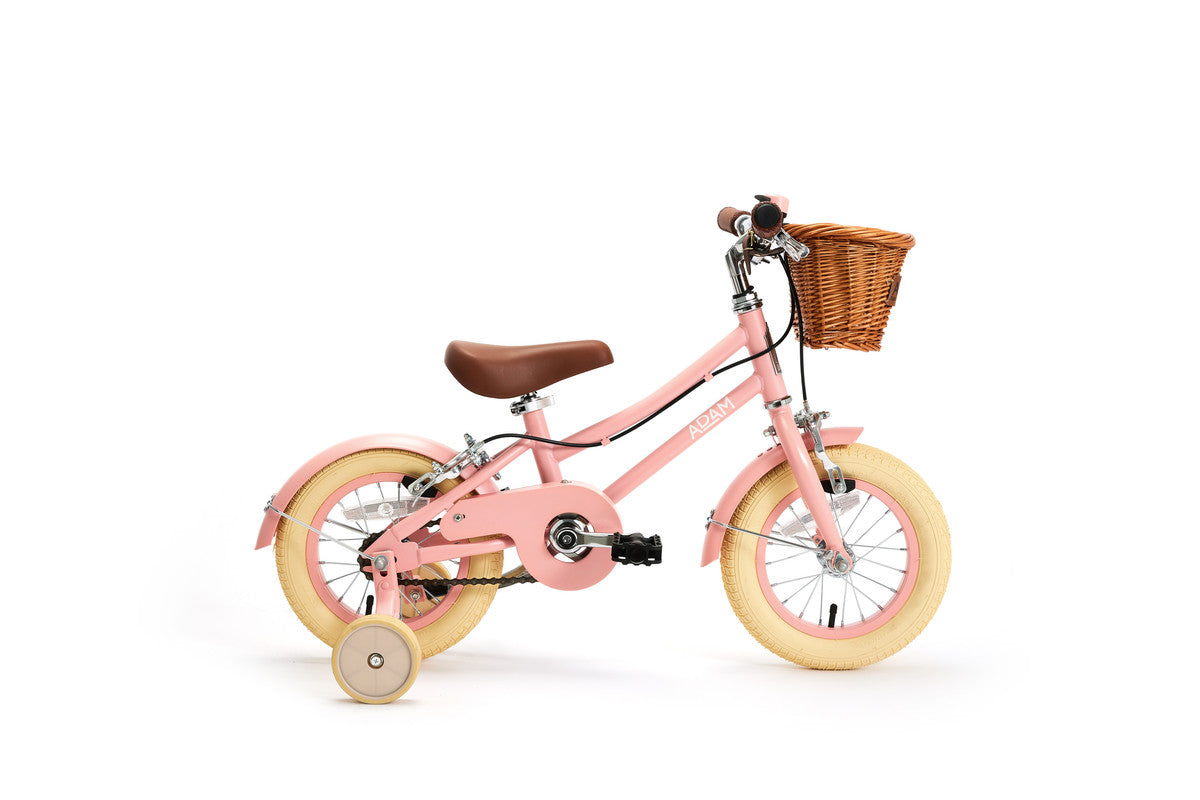 Pink children's bicycle with training wheels and a basket on a white background