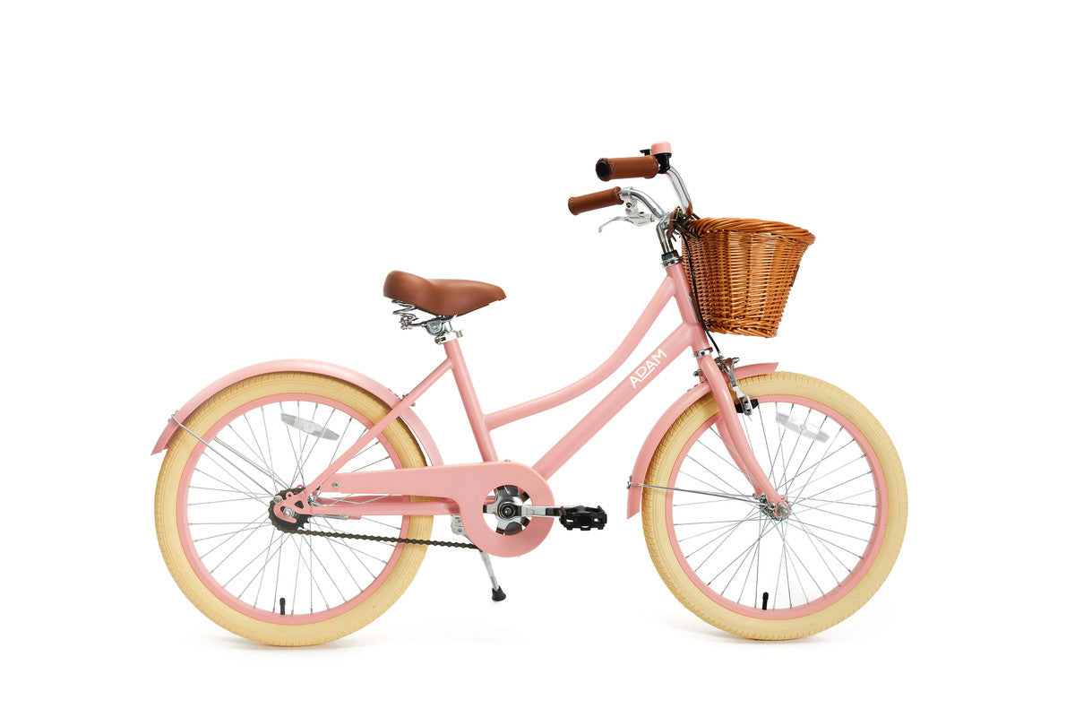 Pink bicycle with a brown basket on a white background