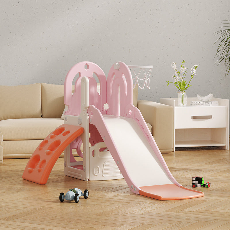 Pink and orange children's slide in a living room setting with toys and a couch.