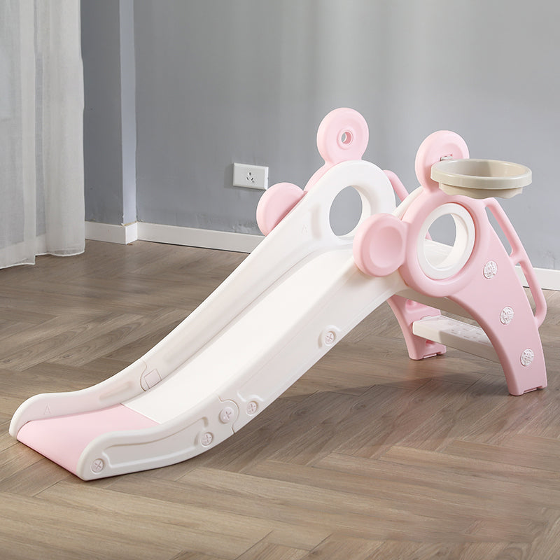 Pink and white children's slide on a wooden floor with a neutral wall background