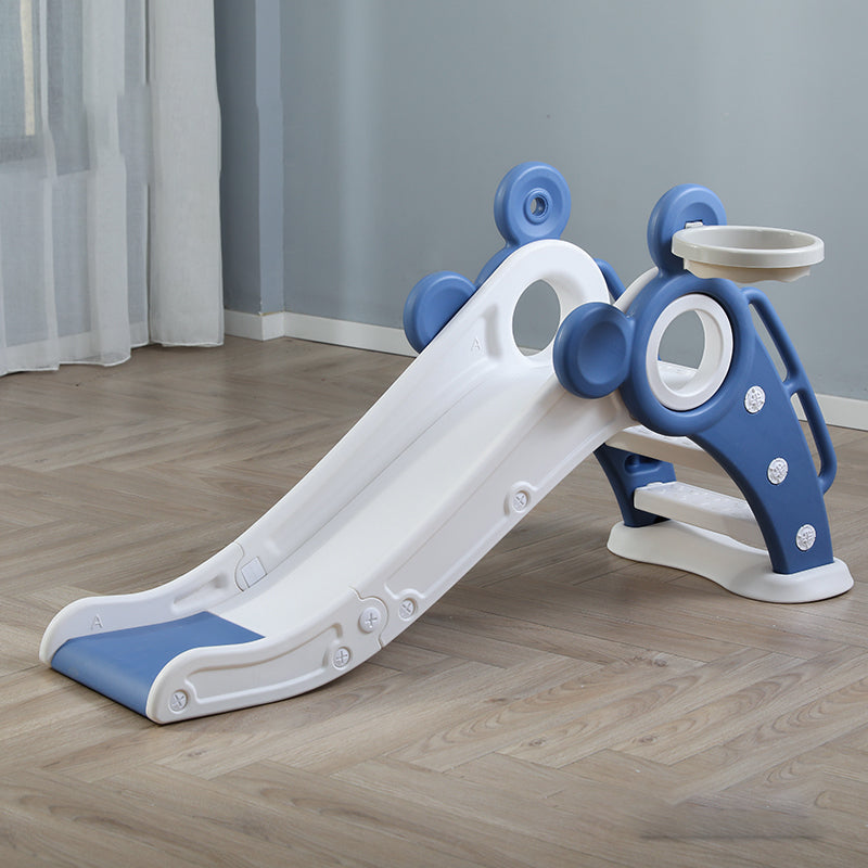Children's slide with blue and white design on a wooden floor.