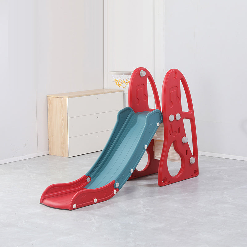 Children's slide with red frame and blue slide surface on a light wooden floor.