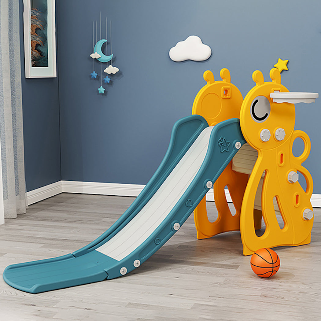 Children's slide with play structure against a blue wall