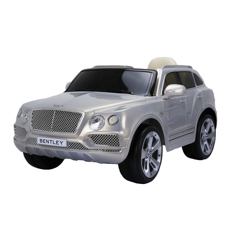 A silver Bentley Bentayga kids electric ride-on car with a luxurious interior and silver wheels.