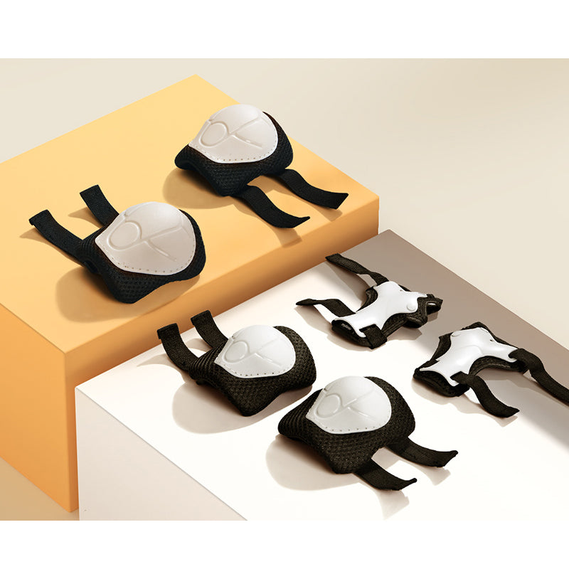 Black and white protective gears on a beige surface.