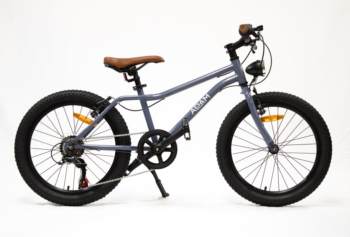 Blue children's bicycle with black tires and a brown seat on a white background