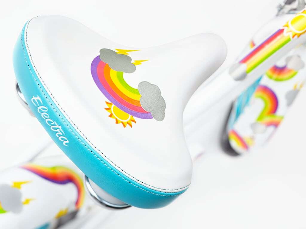 Children's shoes with rainbow and cloud design on a white background