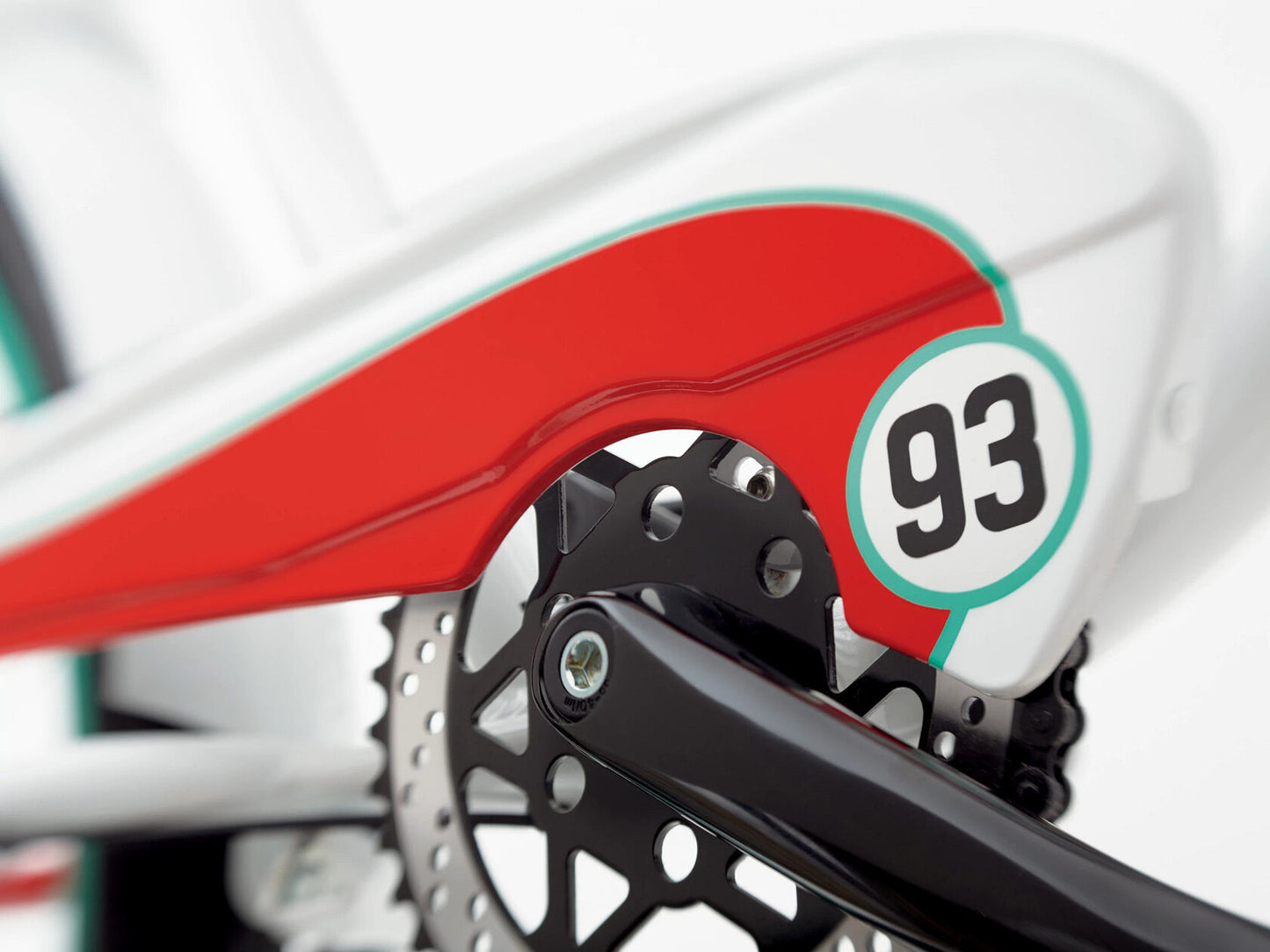 Close-up of a bicycle with a red and white design and number 93 on a blurred background