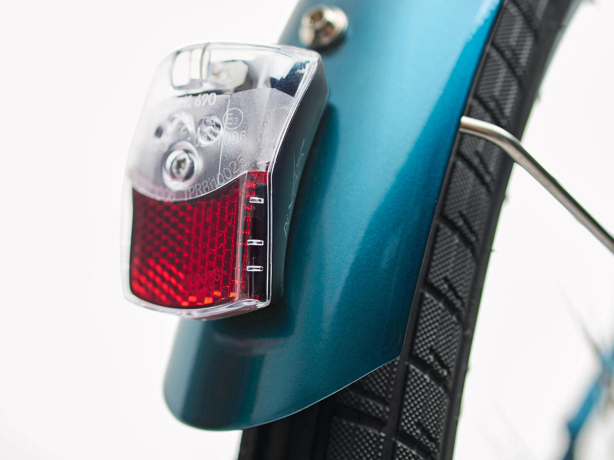 Bicycle tail light attached to a blue bicycle frame