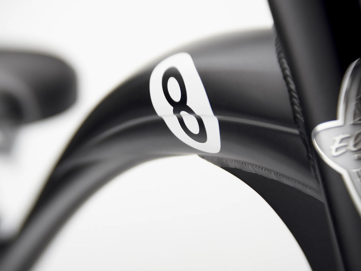 Close-up of a bicycle frame with a number 8 decal and brand logo.