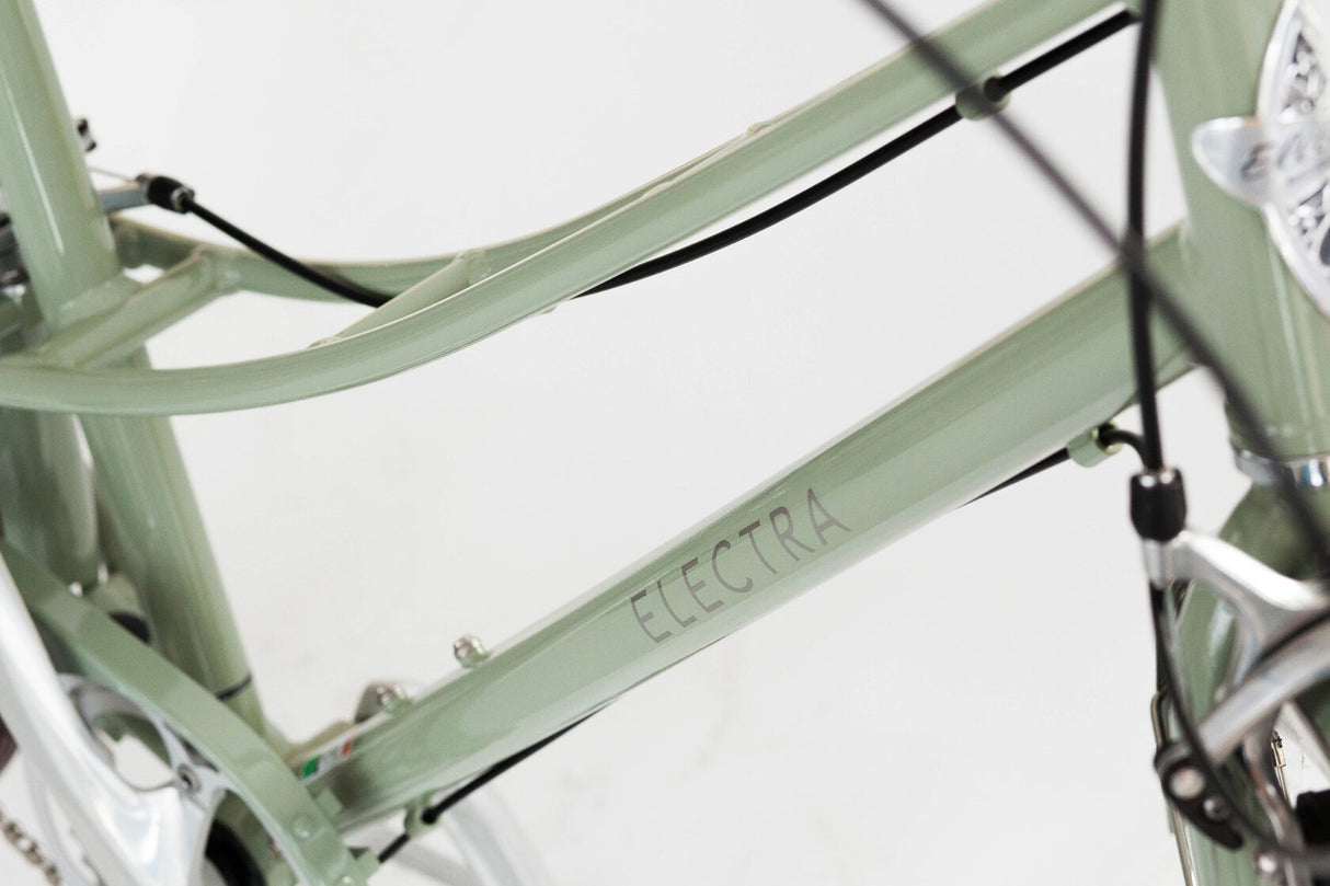 Close-up of a green Electra bicycle frame on a white background