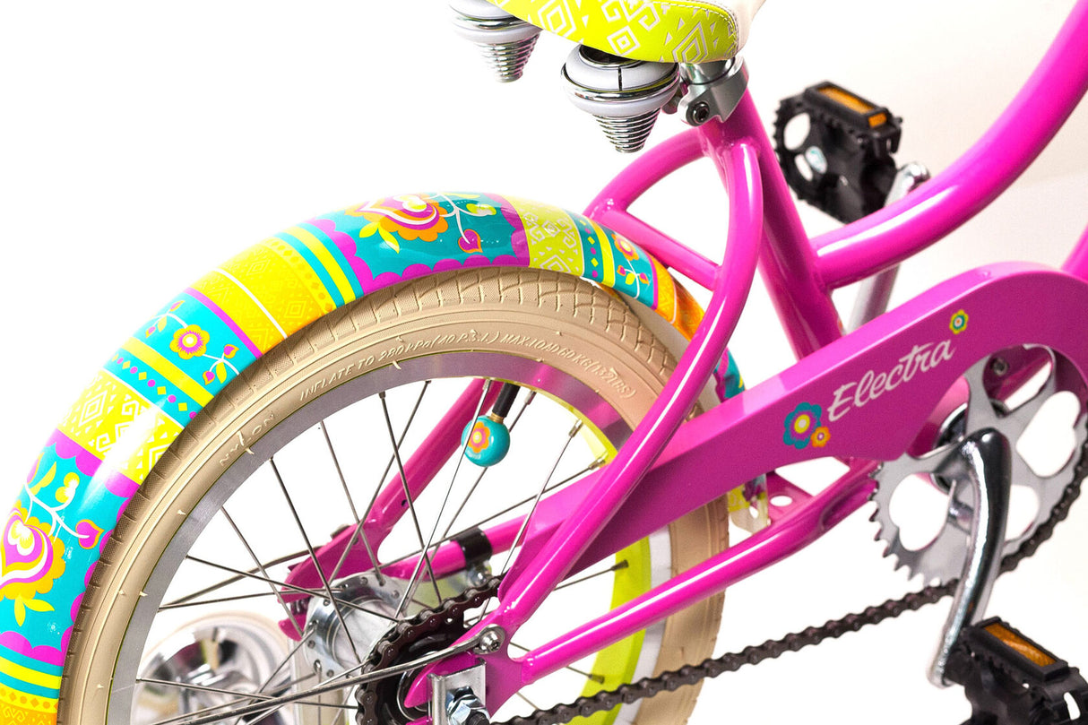 Pink children's bicycle with colorful tires on a white background