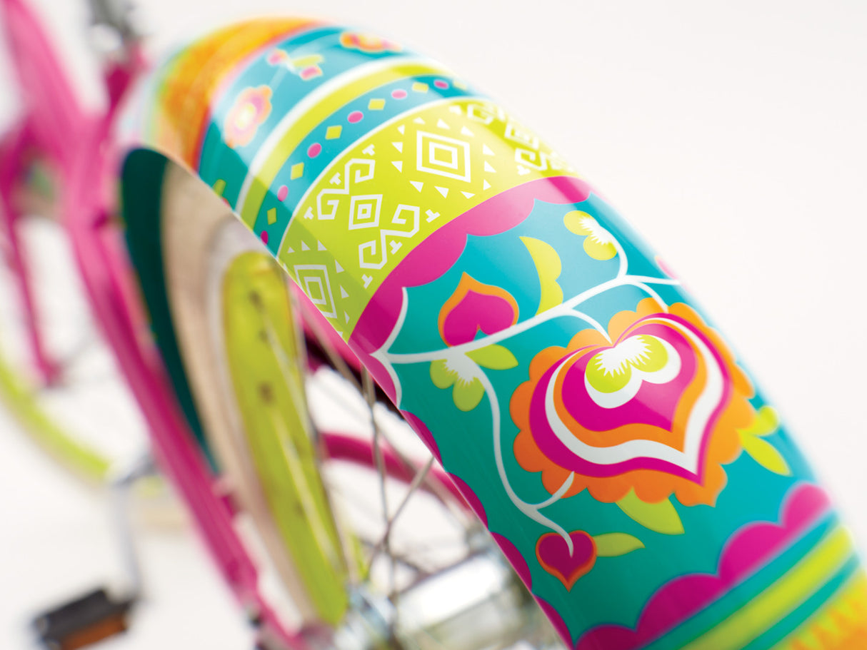 Colorful bicycle seat with heart design on a blurred background