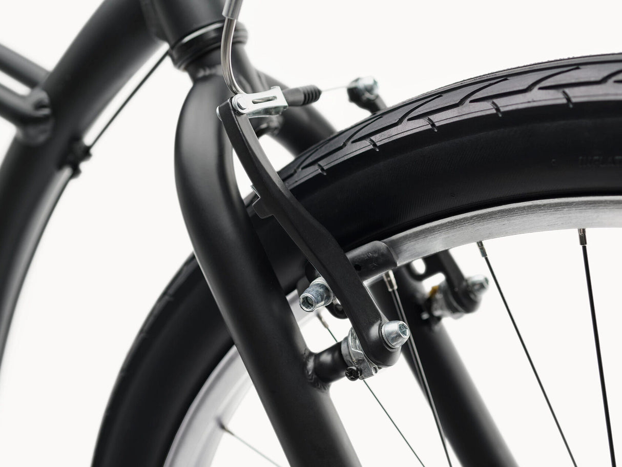 Close-up of a bicycle wheel with a black rim and tire on a white background