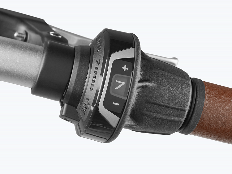 Close-up of bicycle gears with control buttons on a white background