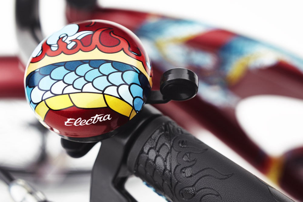 Colorful bike bell with 'Electra' branding on a blurred background