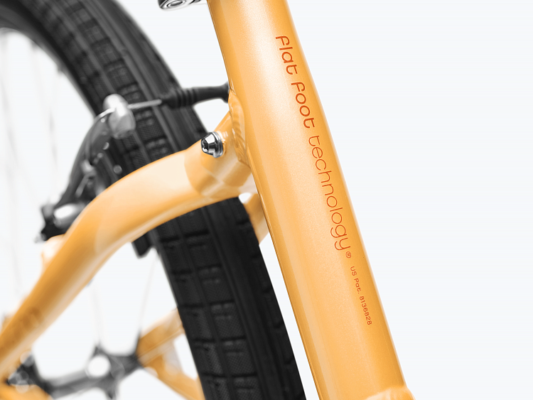 Close-up of a bicycle frame with 'Flat Foot Technology' branding on a white background