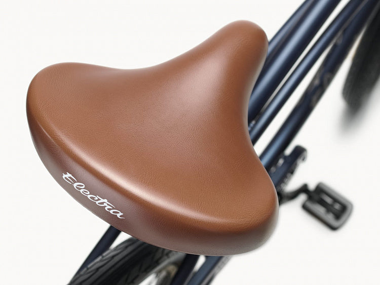 Brown bicycle seat with 'Electra' branding on a white background
