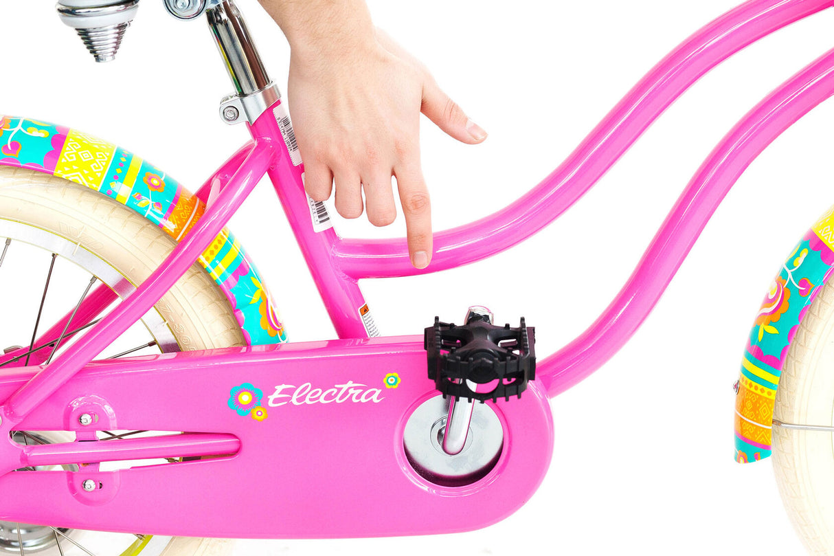 Pink children's bicycle with colorful accents on a white background