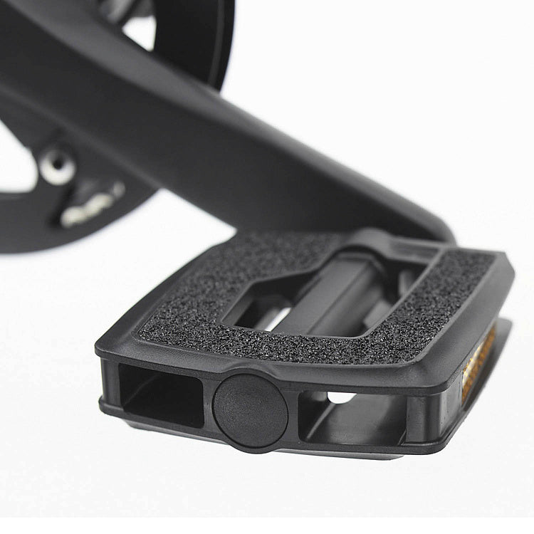 Close-up of a black bicycle pedal on a white background