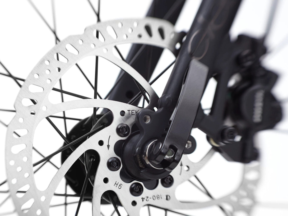 Close-up of a bicycle disc brake system on a white background