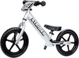 White Strider balance bike with black wheels on a white background
