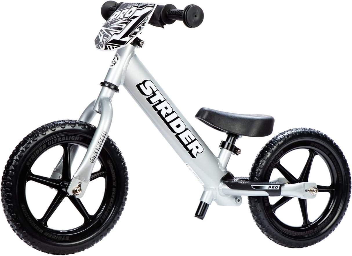 White Strider balance bike with black wheels on a white background