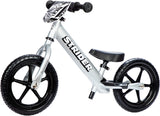 White Strider balance bike with black wheels on a white background
