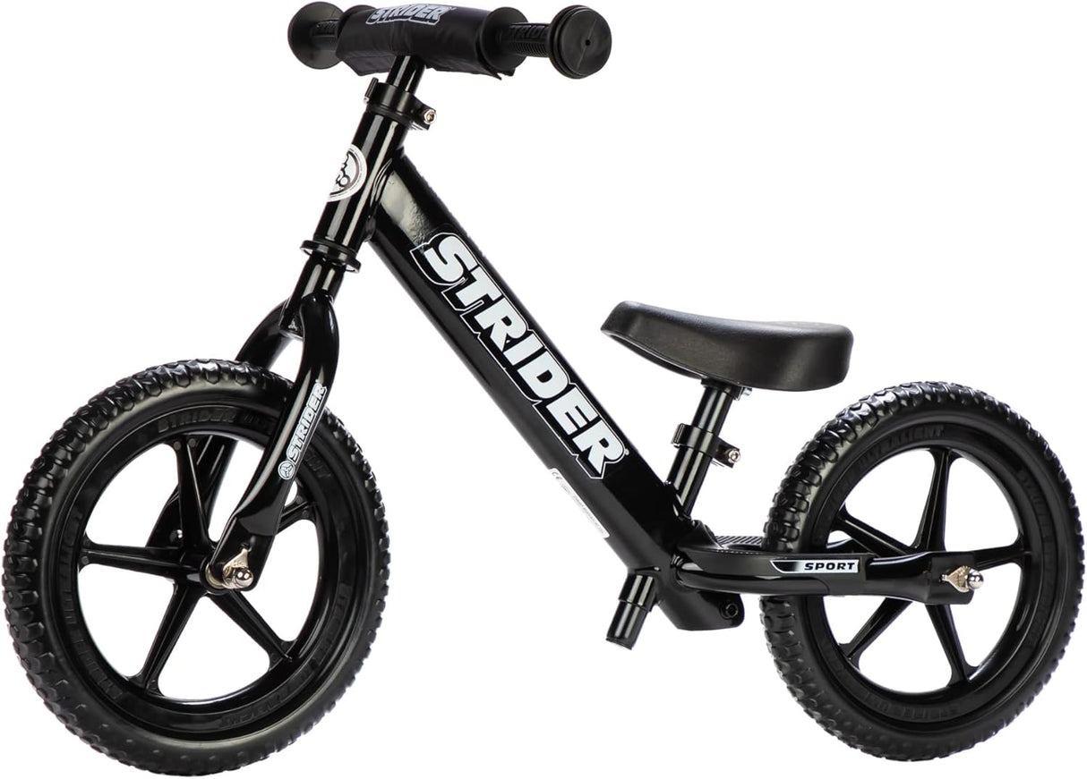 Black Strider balance bike on a white background