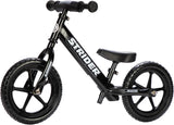 Black Strider balance bike on a white background