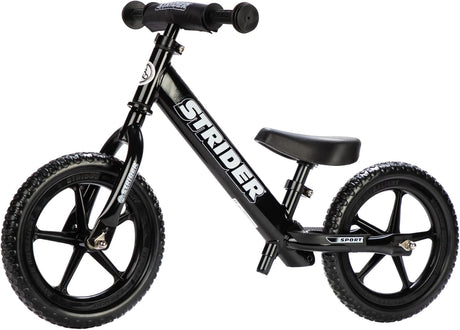 Black Strider balance bike on a white background