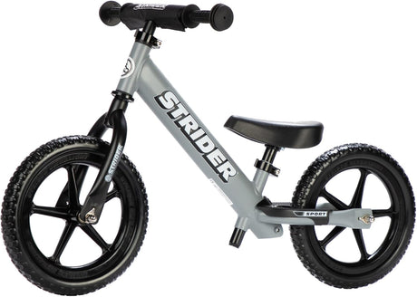 Gray Strider balance bike on a white background