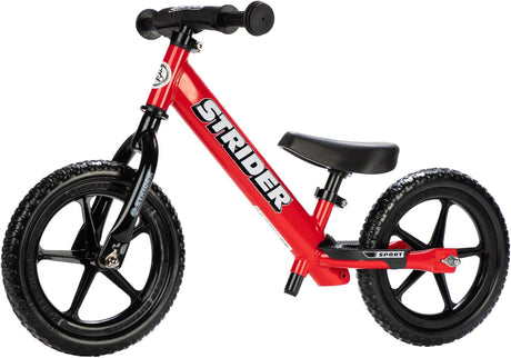 Red Strider balance bike with black seat and wheels on a white background