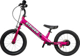 Pink Strider balance bike on a white background