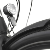 Close-up of a bicycle headlight on a white background
