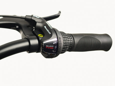 Close-up of a bicycle handlebar with a gear shifter on a white background