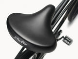 Close-up of a black bicycle seat with 'Electra' branding on a white background